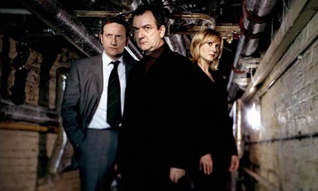 Hunting serial killers - a grim, serious business, set in grim, serious dingy basements. (Crack a smile and we'll have to do the photo again.)